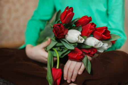 close up of children's hands with a bouquet of flowers, indoorの写真素材