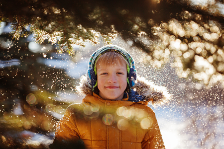 Portrait of a boy walking in the winter nature. Playing with snow. Concept happy childhood.の写真素材