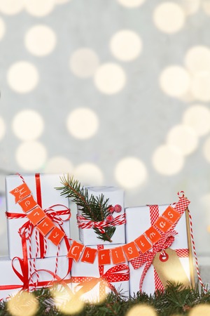 Group Christmas white gift boxes with red ribbons and garland Merry .