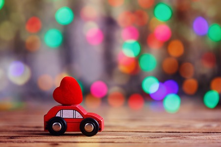 Miniature Car carrying a Red Heart on roof. Holiday concept love.の写真素材
