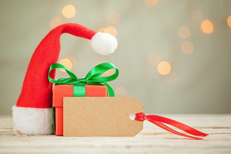 Composition from Christmas box and Santa claus hat with empty blank