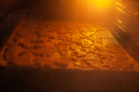 Baking different bisquit oatmeal cookies in ovenの写真素材