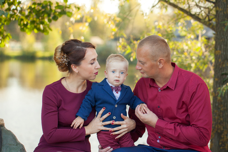 Happy mother, father and son in the park. Happiness in family life in summer day.の写真素材