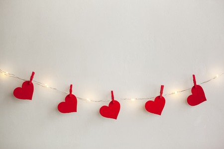 Red hearts hanging on the garland. Valentine's day holiday backgroundの写真素材