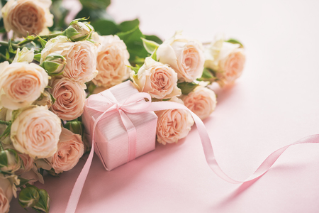 Pink roses flowers and gift or present box pink background. Mothers Day, Birthday, Valentines Day, Womens Day, celebration concept. Space for text.の写真素材
