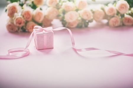 Pink roses flowers and gift or present box pink background. Mothers Day, Birthday, Valentines Day,...