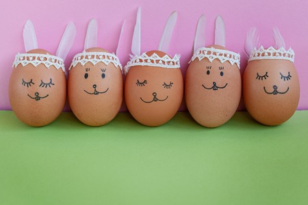 Funny easter bunnies eggs on green paper background with copy space. Happy Easter conceptの写真素材