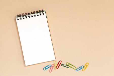 Blank spiral notebook with colorful clips on table. Top viewの写真素材