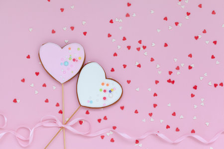Two pink and white hearts shaped gingerbread for Valentines Day, Mother Day or Birthday on pink background. Flatlayの写真素材