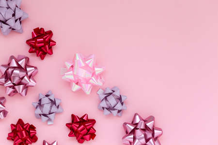 Festive composition with differrent pink bows decorations on pink background. Flat lay and copy...