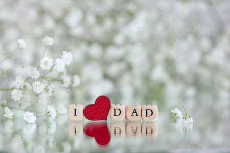 Happy Father s Day. Text I Love Dad on background with blur gypsophila flowers. Greeting card for holiday concept.の写真素材