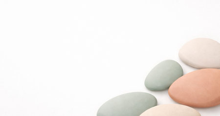 Pebbles on a white background with space for text or imageの写真素材