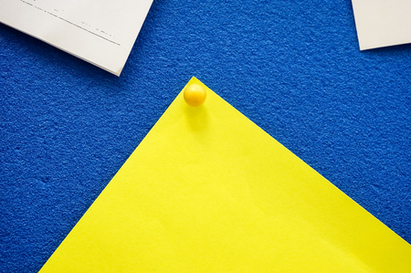 yellow pin with blue boardの写真素材