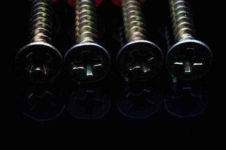 screw head isolated on blackの写真素材