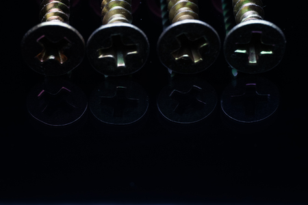 screw head isolated on blackの写真素材