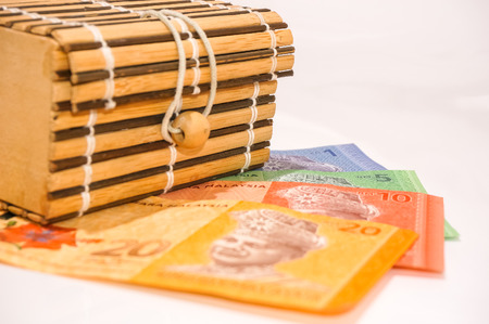 brown box with bank notes isolated on whiteの写真素材