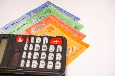 calculator with bank notes isolated on white