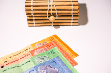 brown gift box on malaysia currency notes isolated on white