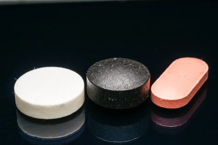 colorful of medication isolated on black