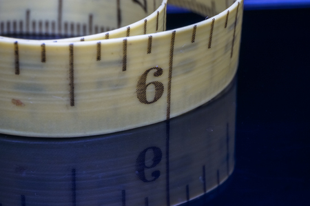 measurement tape with reflection isolated on blackの写真素材