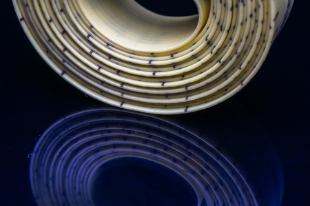 measurement tape with reflection isolated on blackの写真素材