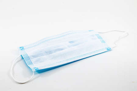closeup view of a disposable surgical face mask isolated on white backgroundの写真素材