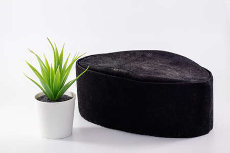 closeup shot of a black songkok isolated on white backgroundの写真素材