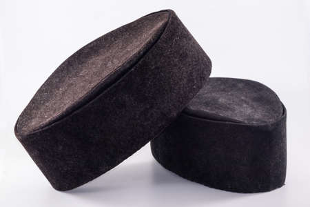 closeup shot of a black songkok isolated on white backgroundの写真素材