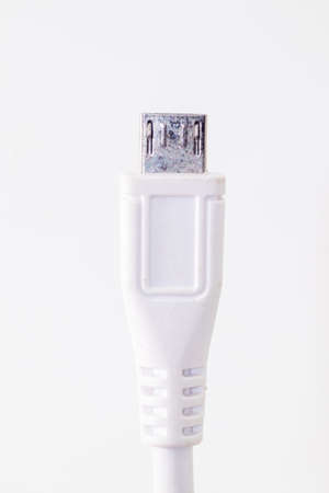 closeup shot of a white usb cable isolated on whiteの写真素材