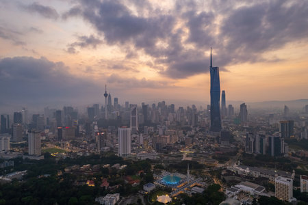 Modern skyscrapers pierce the hazy morning sky over Kuala Lumpur.の写真素材