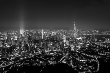 Kuala Lumpur's vibrant skyline at night, a dazzling display of illuminated skyscrapers.の写真素材