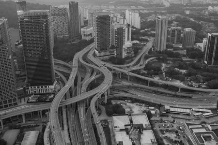 A complex highway network weaves through a dense urban landscape, showcasing the intricate infrastructure of a modern city.の写真素材