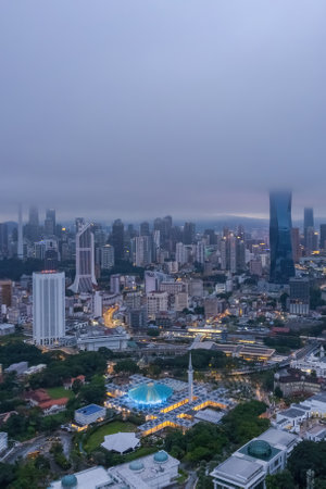 Low clouds drape over the city, creating a serene atmosphere.の写真素材