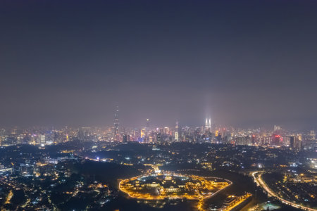 Aerial view of a vibrant city at night, highlighting the intricate network of streets and buildings.の写真素材
