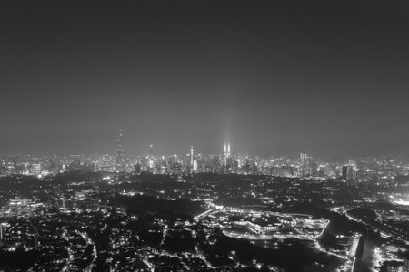 Aerial view of a vibrant city at night, highlighting the intricate network of streets and buildings.の写真素材