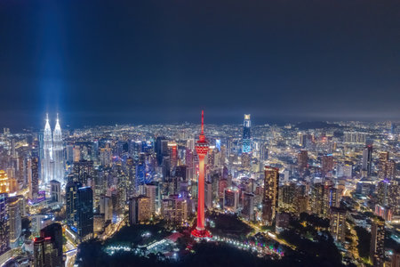 Kuala Lumpur's vibrant skyline at night, a dazzling display of illuminated skyscrapers.の写真素材