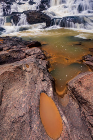 waterfall cascades over the rocks, creating a dynamic flow of water