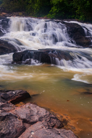 waterfall cascades over the rocks, creating a dynamic flow of waterの写真素材