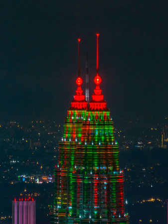 kuala lumpur, malaysia - december 25, 2025 : The Petronas Twin Towers illuminated in festive red and...