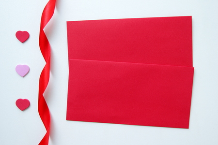 Two red envelopes with three hearts and ribbon for Valentine's Day.の写真素材