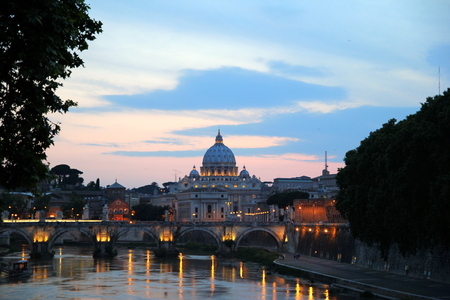 Travel to Rome, Italy. The sunset view on a river, a bridge and a cathedral.の写真素材