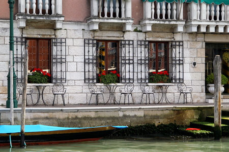 Travel to Venice, Italy. The tables in a cafe near the venetian canal.の写真素材