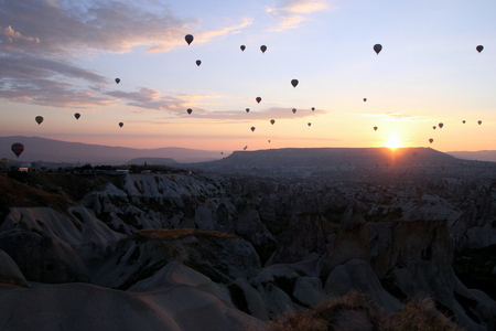 Travel to Goreme, Cappadocia, Turkey. The sunrise in the mountains with a lot of air hot balloons in the sky.の写真素材