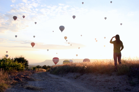 Travel to Goreme, Cappadocia, Turkey. The sunrise in the mountains with a lot of air hot balloons in the sky.の写真素材