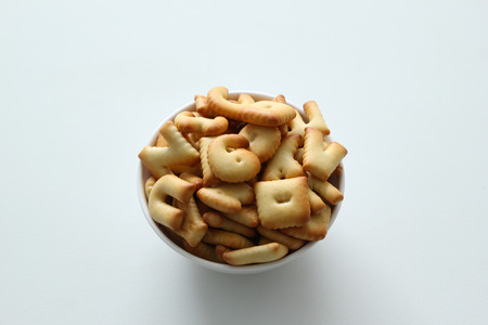 A bowl of cookies on the white background.の写真素材