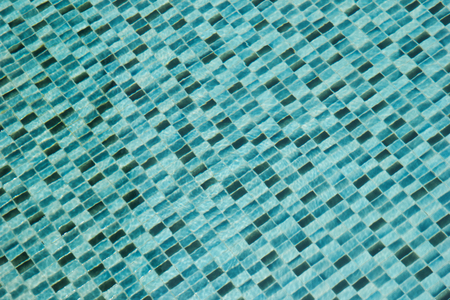 Transparent water in the swimming pool. Blue water texture for background.