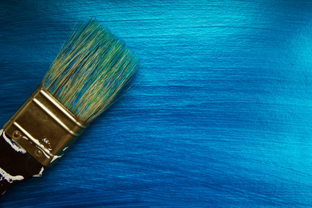 A brush on a blue nacreous color painted background. Abstract  background.の写真素材