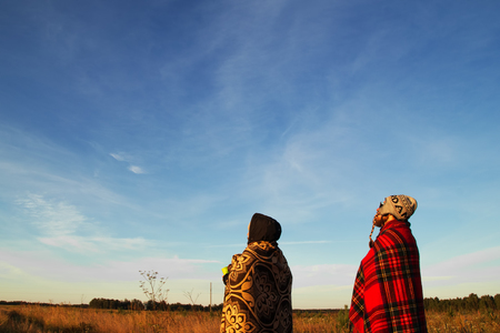 Two young people are looking on the blue sky in the morning.の写真素材