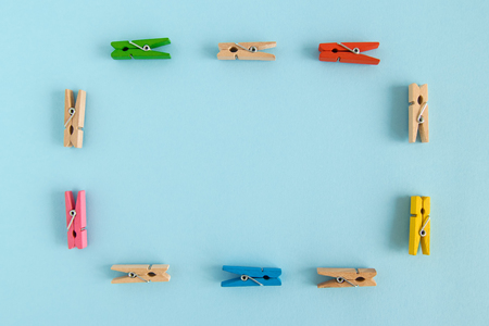 Frame from wooden colorful pins on the blue background with copy space.の写真素材