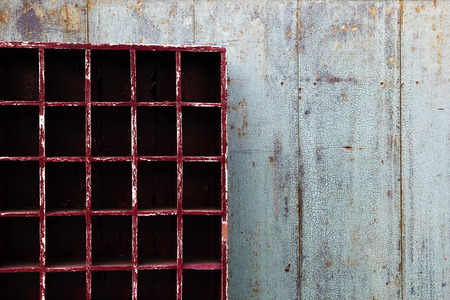 Old shabby blue wooden wall with empty red cupboard. Bangkok, Thailand.
